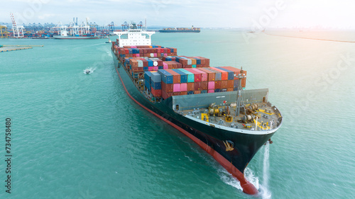 side view Cargo Container ship with contrail in the ocean ship carrying container and running for import export concept technology freight shipping by ship