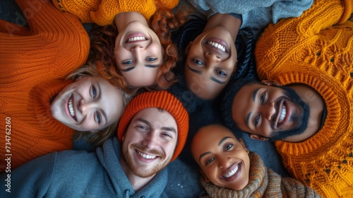 Six friends lying down in a circle smiling at the camera, wearing cozy autumn-colored sweaters, generative ai