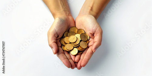 Person holding handful of coins in hands photo