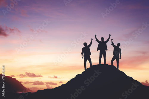 Silhouette of a team celebrating a victory against sunset background, concept of victory and leadership