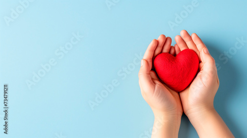 Woman s hands holding red heart on grey background. Valentine s day  health care  world heart day  world health day.