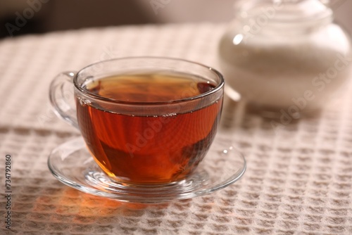 Aromatic tea in cup on table, closeup