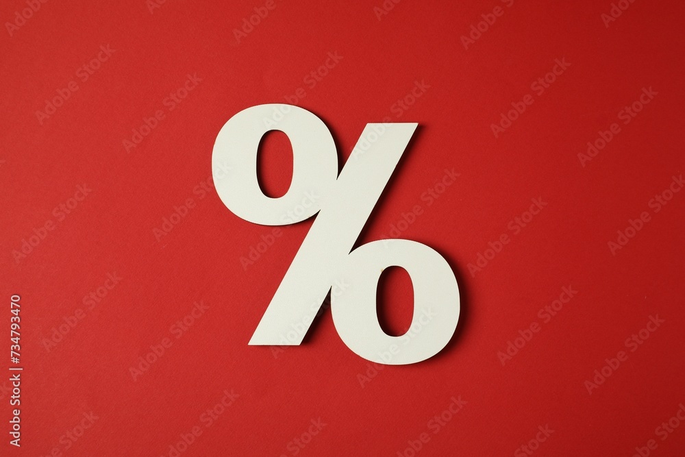 White percent sign on red background, top view White percent sign on red background, top view
