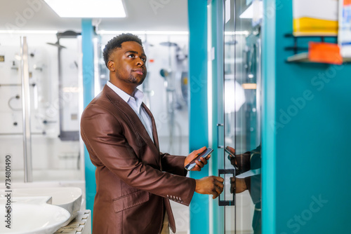 Portrait of buyer in bathroom store. Man is choosing bathtub for his apartment.