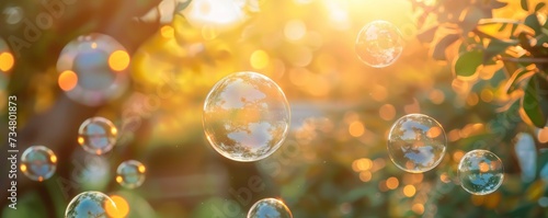 Abstract beautiful transparent soap bubbles floating on sunset background
