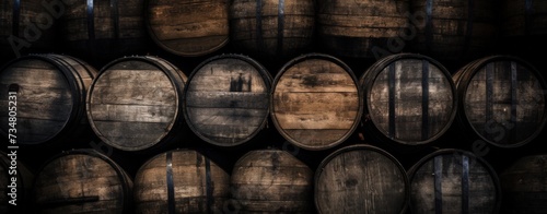 Old wooden whiskey, scotch, wine barrels stack in a warehouse. AI generated image