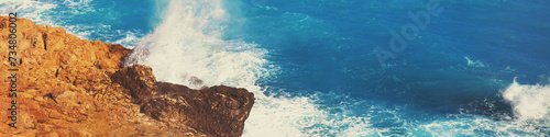 Rocky seashore. Stormy sea. Beautiful wild nature. Horizontal banner