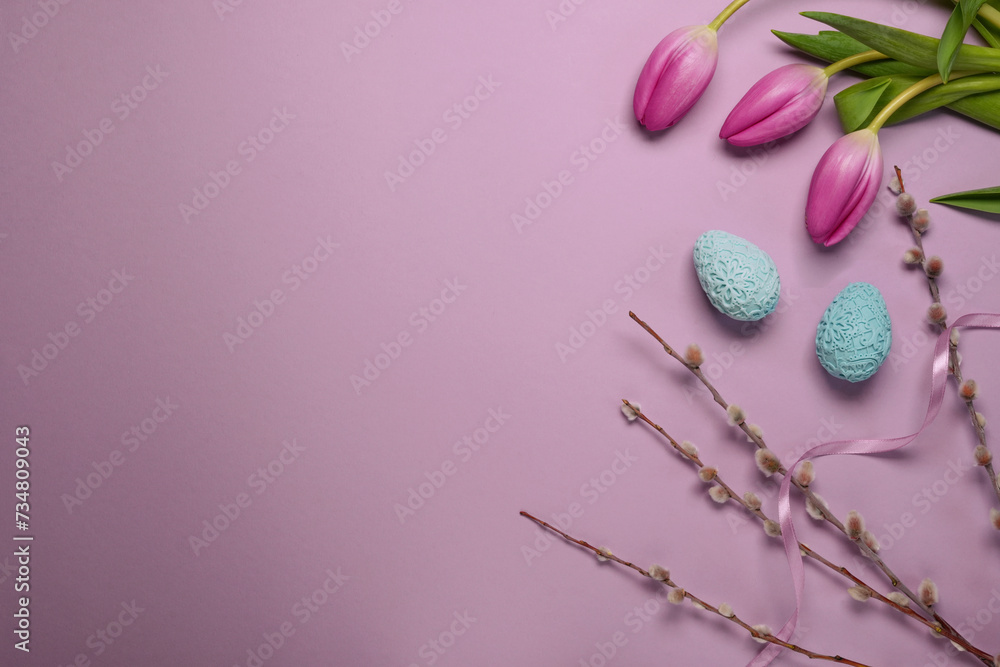 Easter holiday greeting, tilips, eggs, pussy willow. Spring season on pastel color. Top view, flat lay. Space fot text.