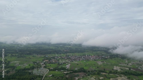 Riverside Reverie: Aerial Morning Symphony of Town, River, and Morning Fog.