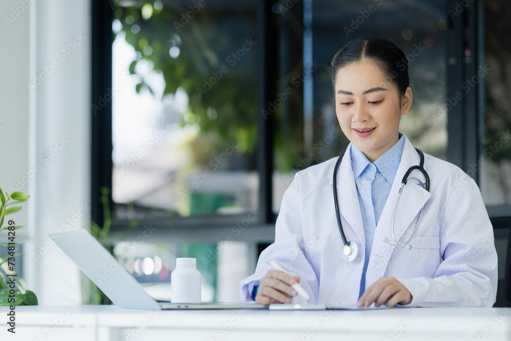 Asian female doctor working with laptop and health personal data in modern clinic, Healthcare and medical concept. Asian female doctor working with laptop and health personal data in modern clinic, Healthcare and medical concept.