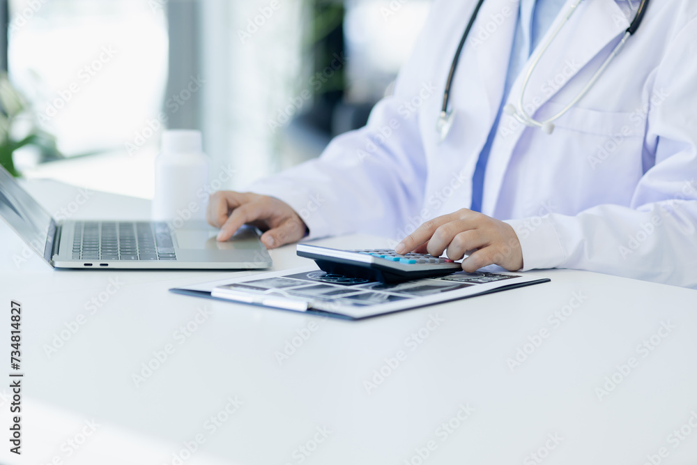 Asian female doctor working with laptop and health personal data in modern clinic, Healthcare and medical concept. Asian female doctor working with laptop and health personal data in modern clinic, Healthcare and medical concept.