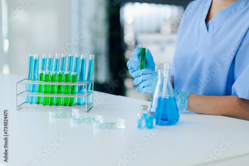 Asian female scientist or medical technician working with a blood lab test in the research lab  Healthcare and medical concept.