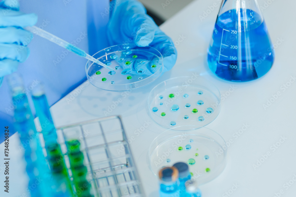 Asian female scientist or medical technician working with a blood lab test in the research lab, Healthcare and medical concept. Asian female scientist or medical technician working with a blood lab test in the research lab, Healthcare and medical concept.