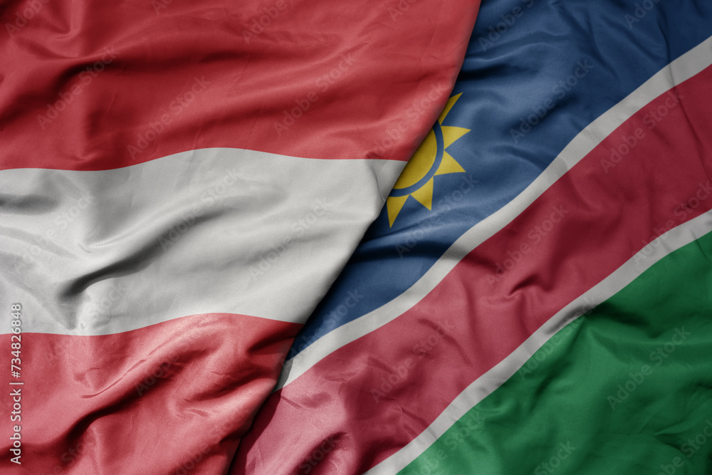 big waving national colorful flag of namibia and national flag of austria .