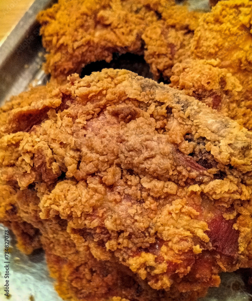 Side view. Crispy kentucky fried chicken is fried in a spiced flour which has been seasoned. Selective focus.
Side view. Crispy kentucky fried chicken is fried in a spiced flour which has been seasoned. Selective focus.