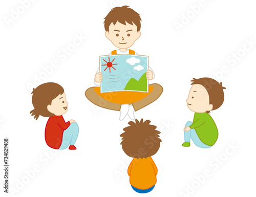 男性の保育士が子ども達に笑顔で絵本の読み聞かせをしている様子
