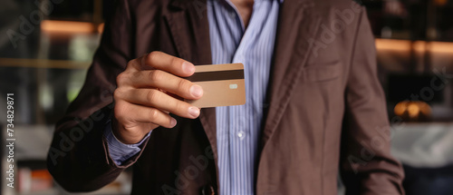 Businessman Presenting Credit Card for Payment photo