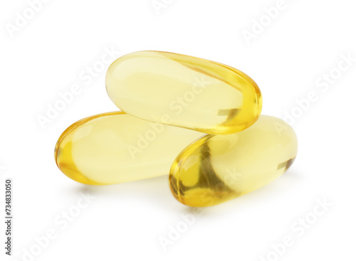 Many yellow vitamin capsules isolated on white