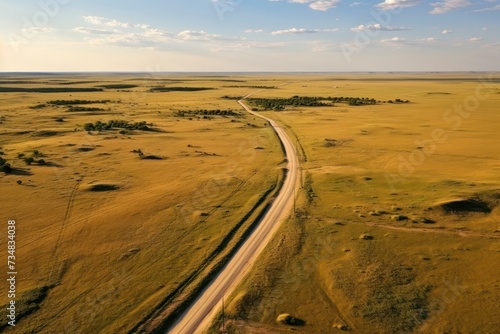 aerial view of road through prairie landscape in summer