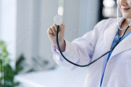 Asian female doctor holding stethoscope in hand, Healthcare and medical concept.