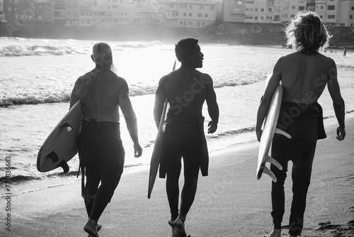 Multi generational surfer men having walking on the beach before surf session - Multiracial people, lifestyle and sport concept - Focus on center african male head