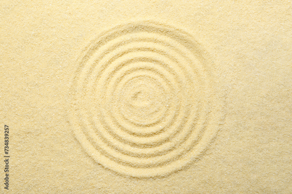 Zen rock garden. Circle pattern on beige sand, top view Zen rock garden. Circle pattern on beige sand, top view