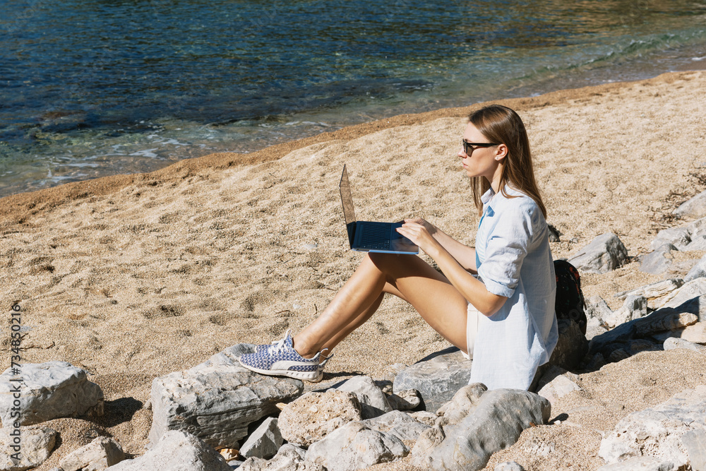 The sun-kissed sand becomes the unconventional office space for a young freelancer, who effortlessly combines her love for the beach with her remote work