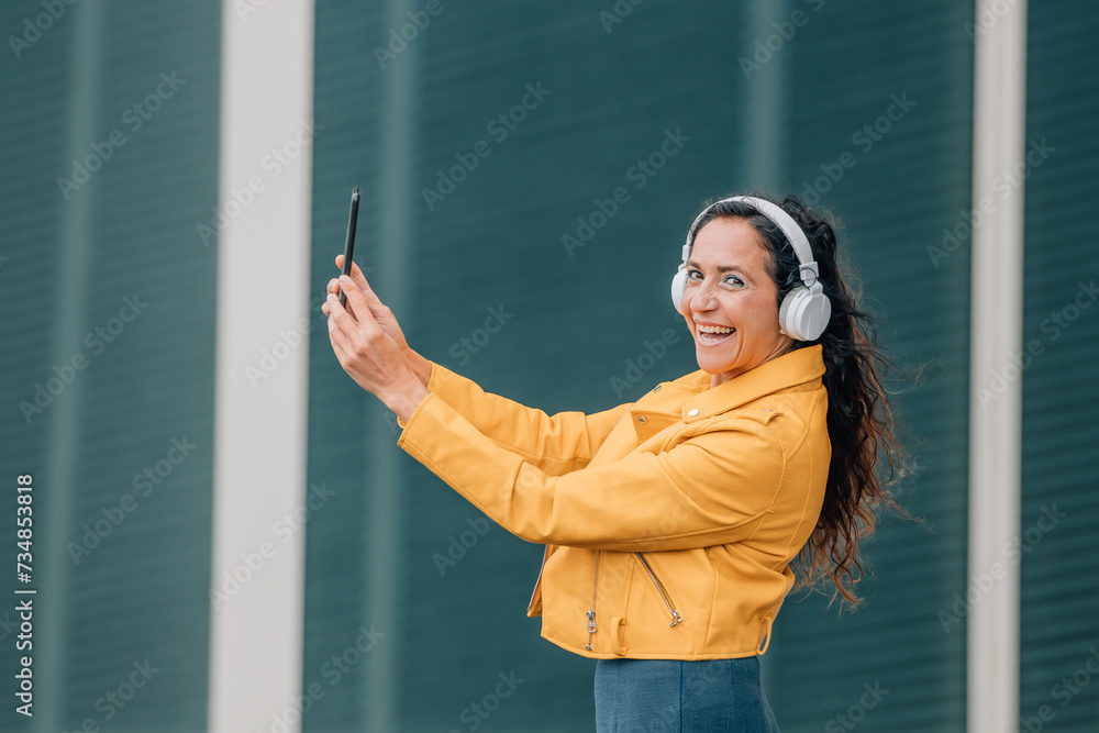 woman with headphones and mobile phone or smartphone