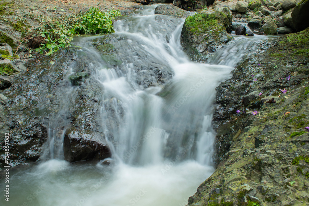 Fototapeta premium Waterfall. Long exposure waterfall photo. Transference. Long exposure. Long exposure photo of smooth waterfall flowing down steps. Rize, Türkiye. 