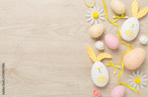 Easter eggs and decoration on wooden background, top view