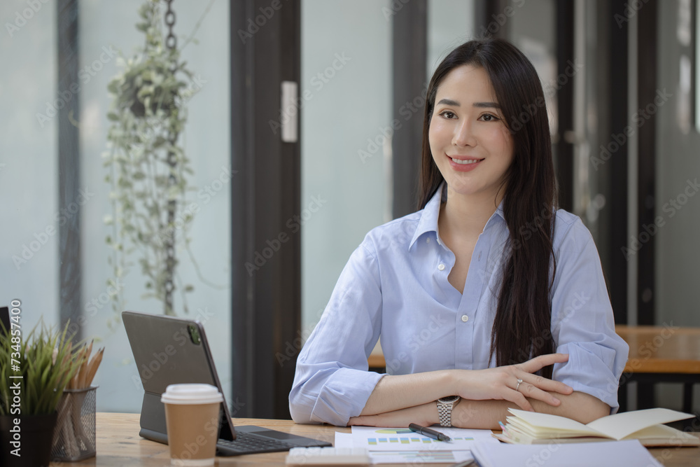 Happy asian accounting businesswoman working in office working space, Asian female employee using laptop at workplace. Happy asian accounting businesswoman working in office working space, Asian female employee using laptop at workplace.