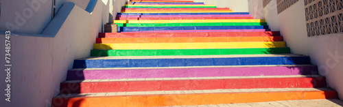 Colorful staircase in the park. The steps are painted in rainbow colors. Nerja, Malaga, Spain. Horizontal banner