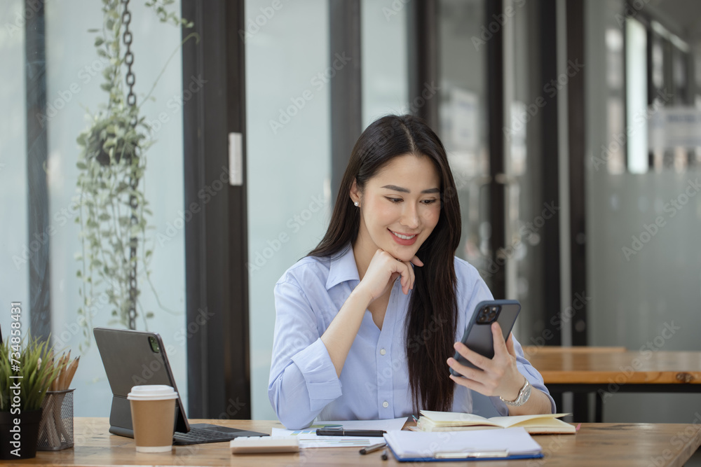 Happy asian young businesswoman excited with smartphone at workplace, Excited happy Asian woman. Happy asian young businesswoman excited with smartphone at workplace, Excited happy Asian woman.