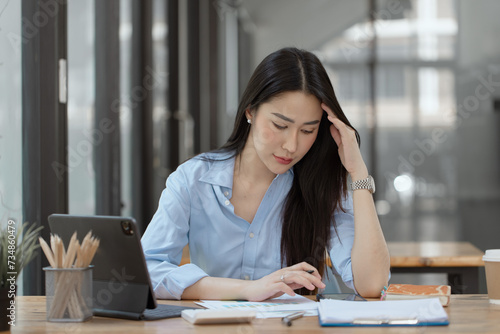 Asian businesswoman are stressed and tired from work sitting at desk in the office, feeling sick at work, stress from work.