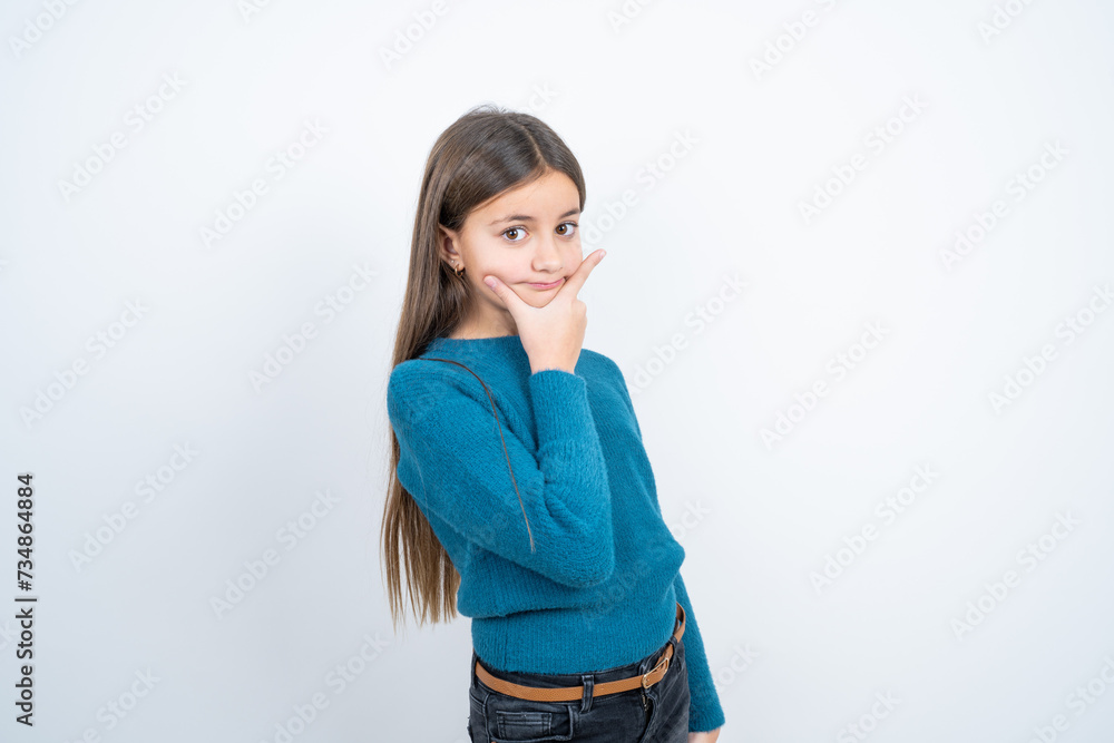 Young beautiful teen girl wearing blue T-shirt Thinking worried about a question, concerned and nervous with hand on chin. Young beautiful teen girl wearing blue T-shirt Thinking worried about a question, concerned and nervous with hand on chin.