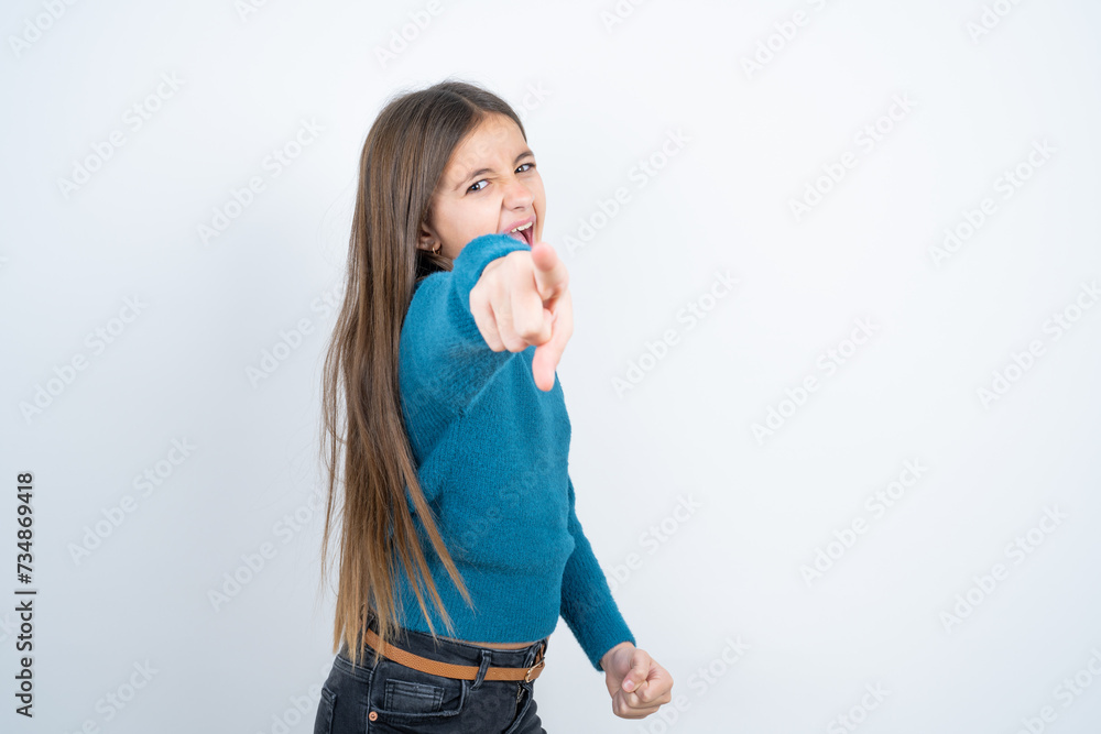 Young beautiful teen girl wearing blue T-shirt pointing displeased and frustrated to the camera, angry and furious ready to fight with you. Young beautiful teen girl wearing blue T-shirt pointing displeased and frustrated to the camera, angry and furious ready to fight with you.