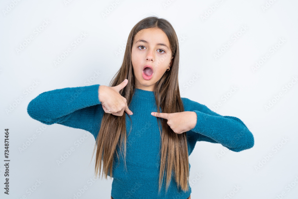 Embarrassed Young beautiful teen girl wearing blue T-shirt indicates at ...