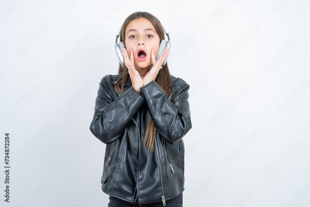Shocked Young beautiful teen girl wearing biker jacket stares fearful ...
