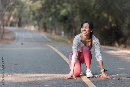 A fit woman enjoys a healthy jog in a park filled with summery green