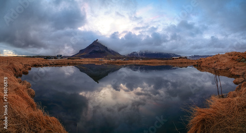 Arnarstapi village with reflections at the lake in Iceland photo