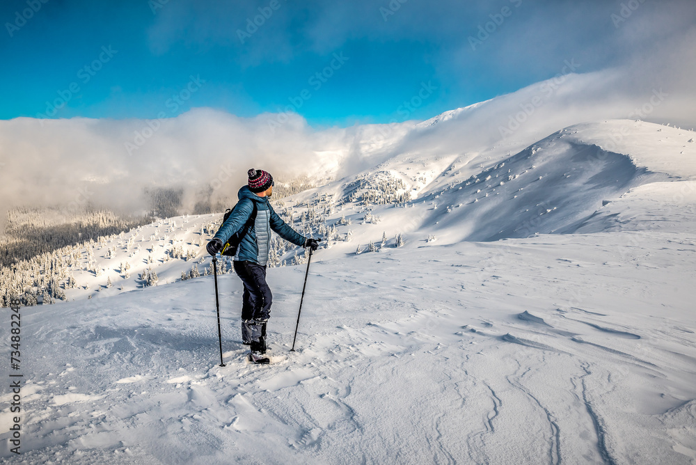 Tourist hiker in winter snowy mountains Tourist hiker in winter snowy mountains