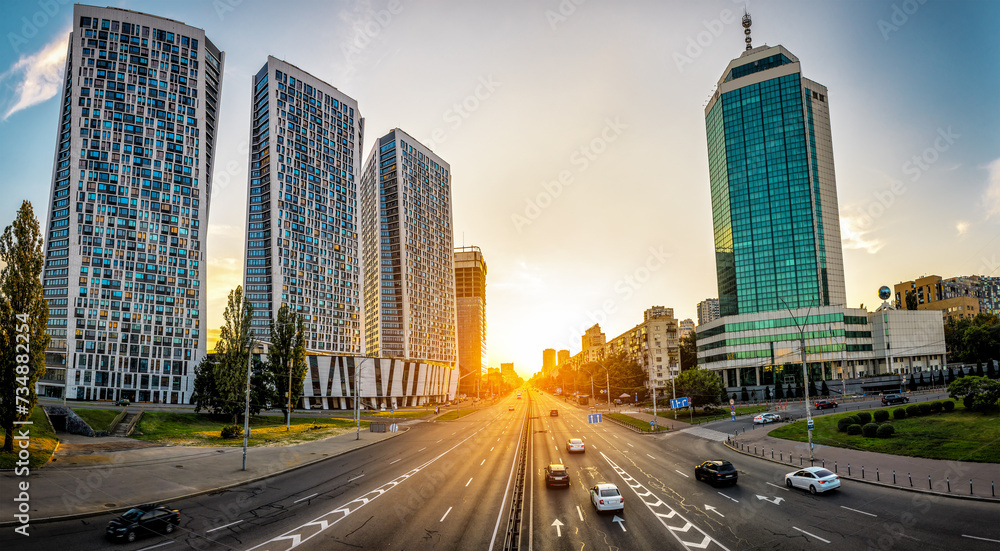 Three modern apartment building and avenue at sunset. Kyiv. Ukraine