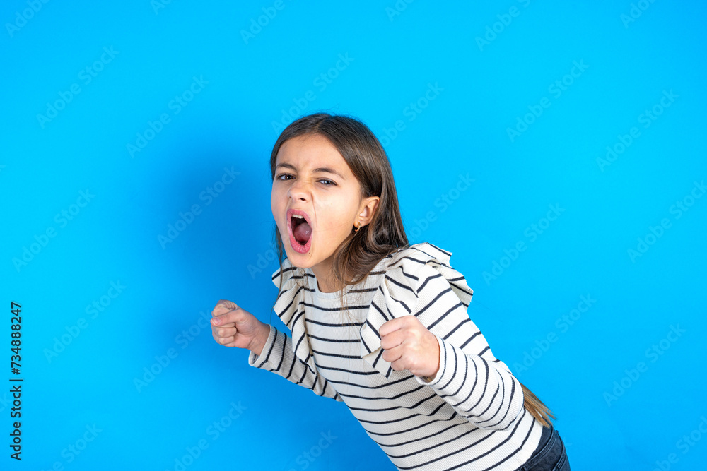 beautiful kid girl wearing plaid shirt very happy and excited doing winner gesture with arms raised, smiling and screaming for success. Celebration concept. beautiful kid girl wearing plaid shirt very happy and excited doing winner gesture with arms raised, smiling and screaming for success. Celebration concept.