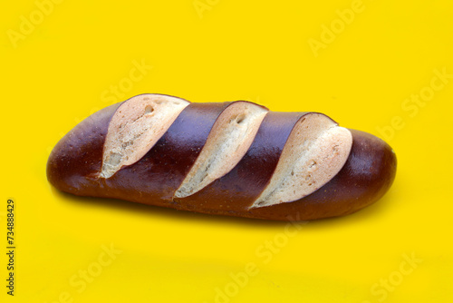 Plain Laugen bread on yellow background. photo