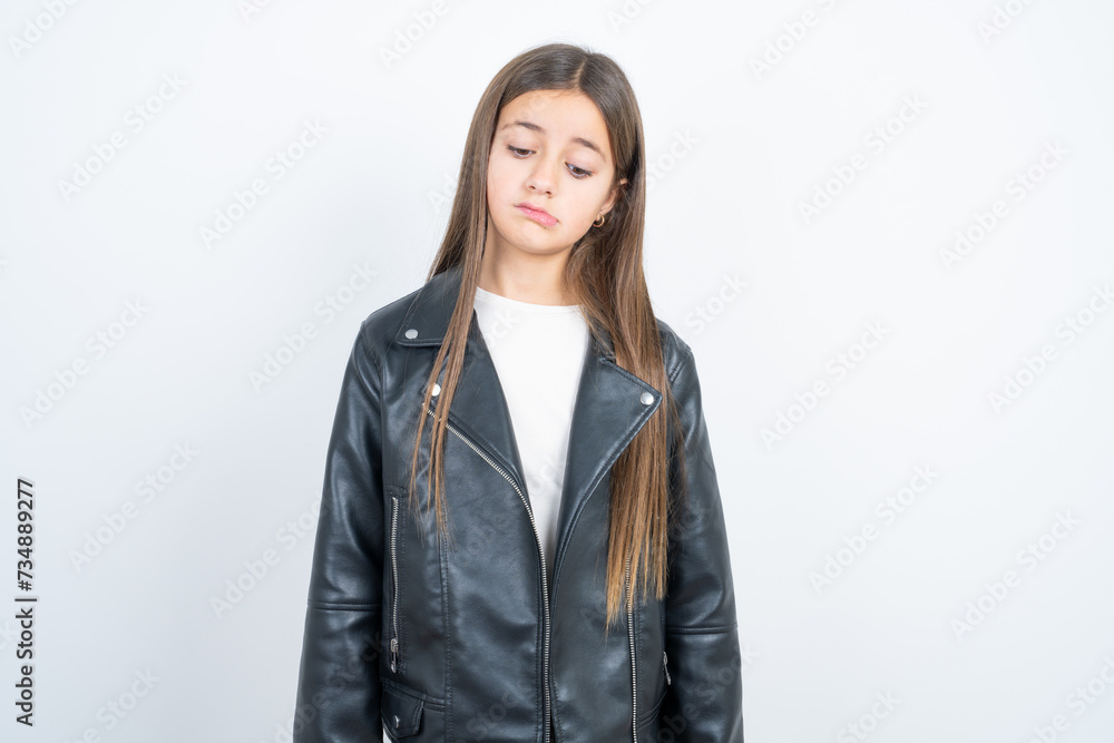 Young beautiful teen girl wearing biker jacket depressed and worry for distress, crying angry and afraid. Sad expression. Young beautiful teen girl wearing biker jacket depressed and worry for distress, crying angry and afraid. Sad expression.