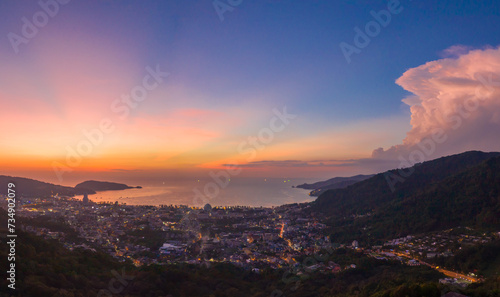 aerial panorama scenery sunset above Patong beach Phuket .Scene of Colorful romantic sky sunset with panorama city scape. .The lights twinkle at dusk background. .nature and travel concept.