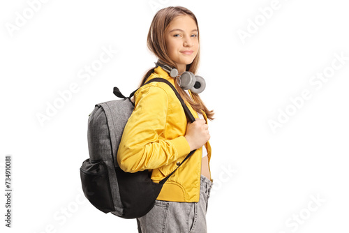 Female teen student with headphones and backpack