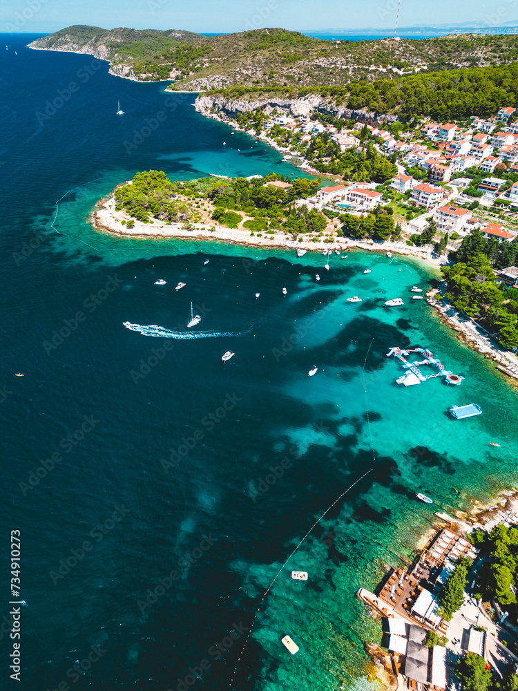 Aerial view of a serene coastal town surrounded by turquoise waters. Croatia