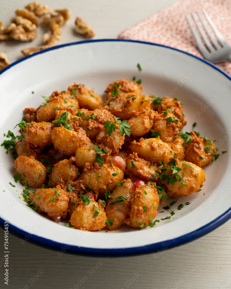 Gnocchi with pesto rosso sauce. Italian potato gnocchi with traditional sauce. Gnocchi with pesto rosso sauce. Italian potato gnocchi with traditional sauce.