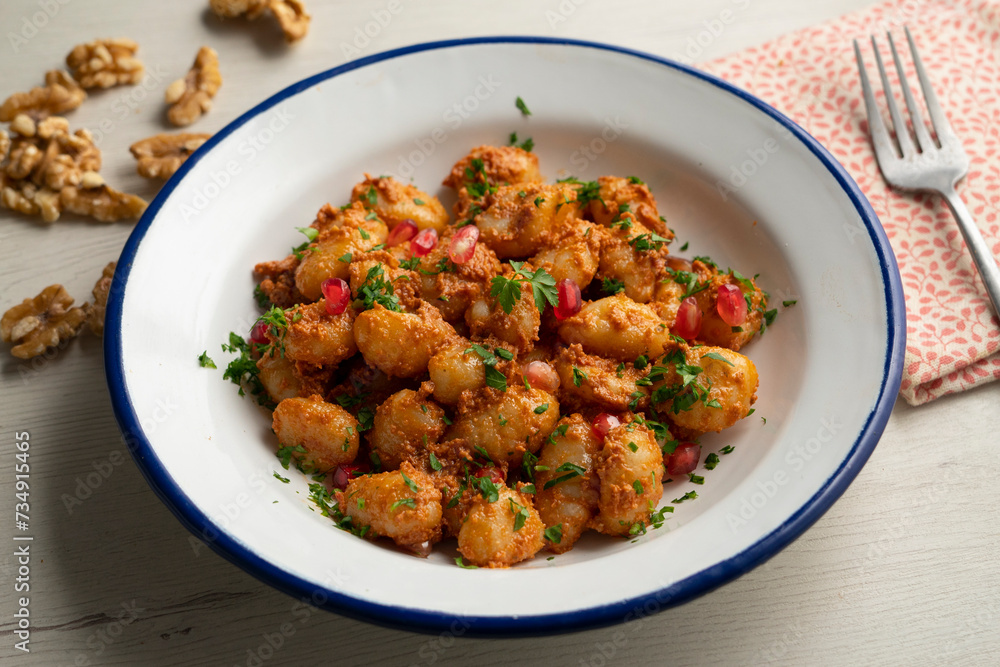 Gnocchi with pesto rosso sauce. Italian potato gnocchi with traditional sauce. Gnocchi with pesto rosso sauce. Italian potato gnocchi with traditional sauce.